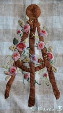 Applique work comes alive when embroidered leaves and tendrils are added